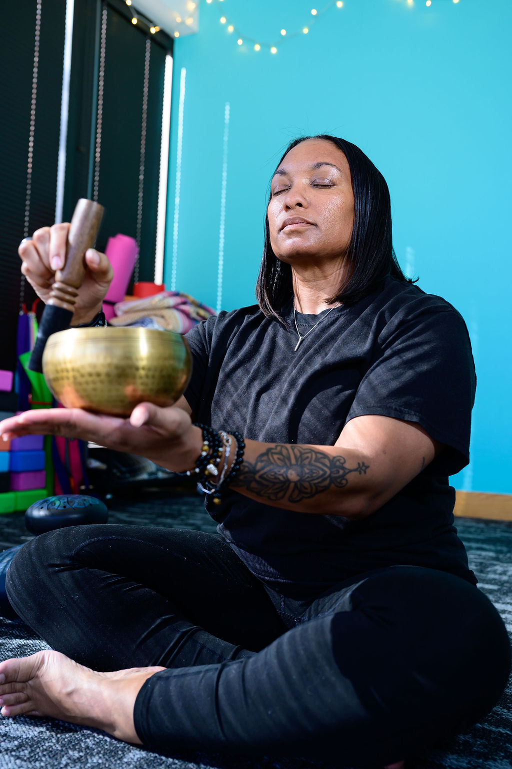 Jessica sitting peacefully with a singing bowl